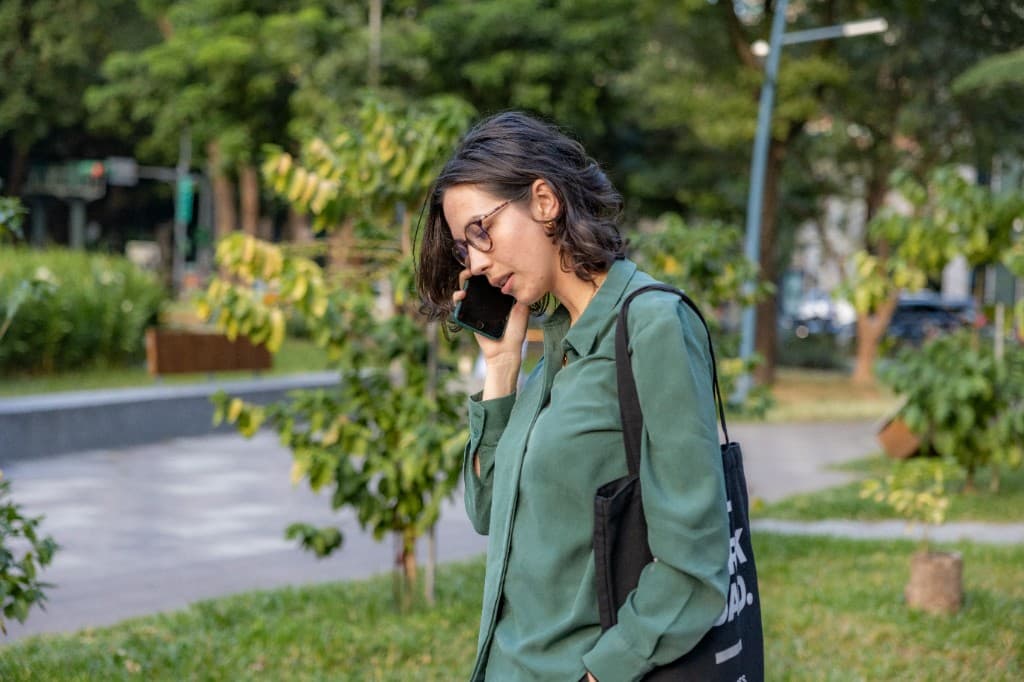 Person taking an after-hours call on the phone outdoors